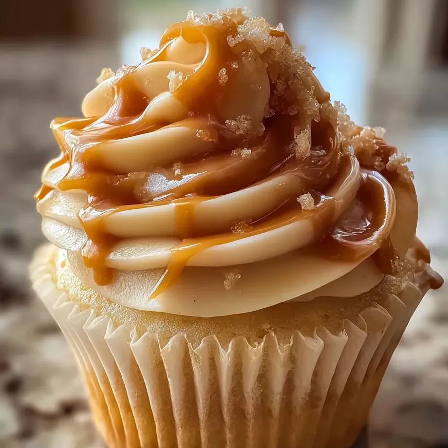 A cupcake piled high with creamy caramel frosting.