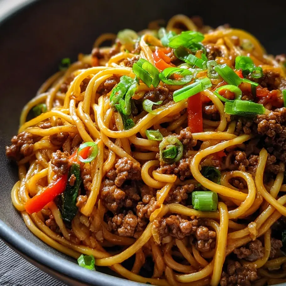 Noodles and beef with veggies in a bowl.