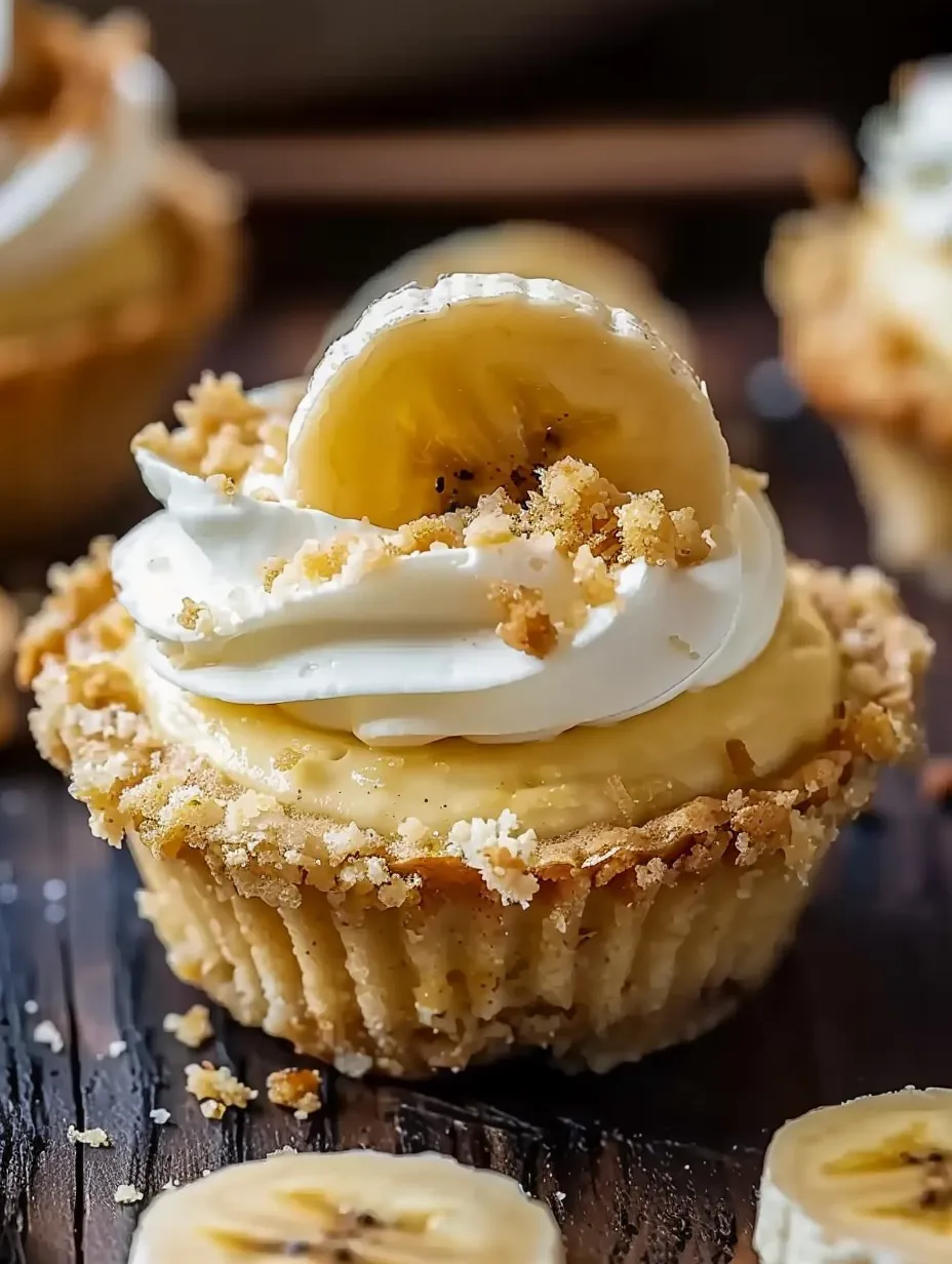 A cupcake with a banana on top.