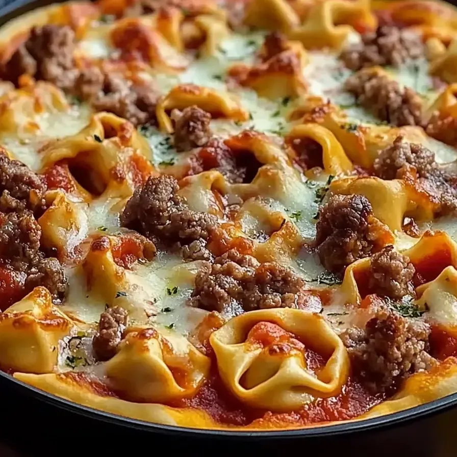 A pizza topped with various meats and melted cheese.