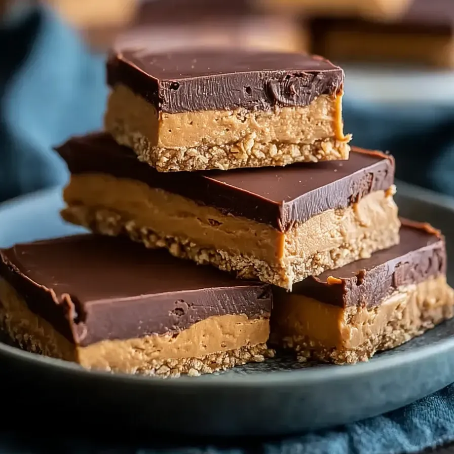 Several peanut butter chocolate bars stacked high.