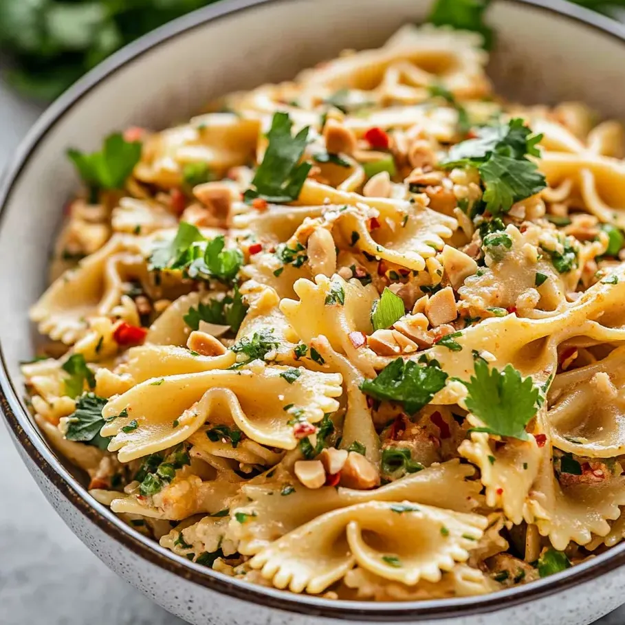 Chilled noodles loaded with veggies and nuts in a bowl.