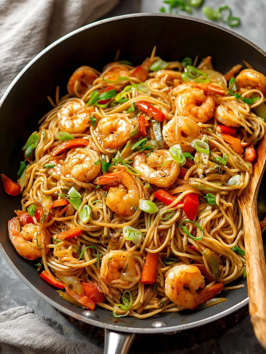 A bowl full of shrimp and colorful vegetables.