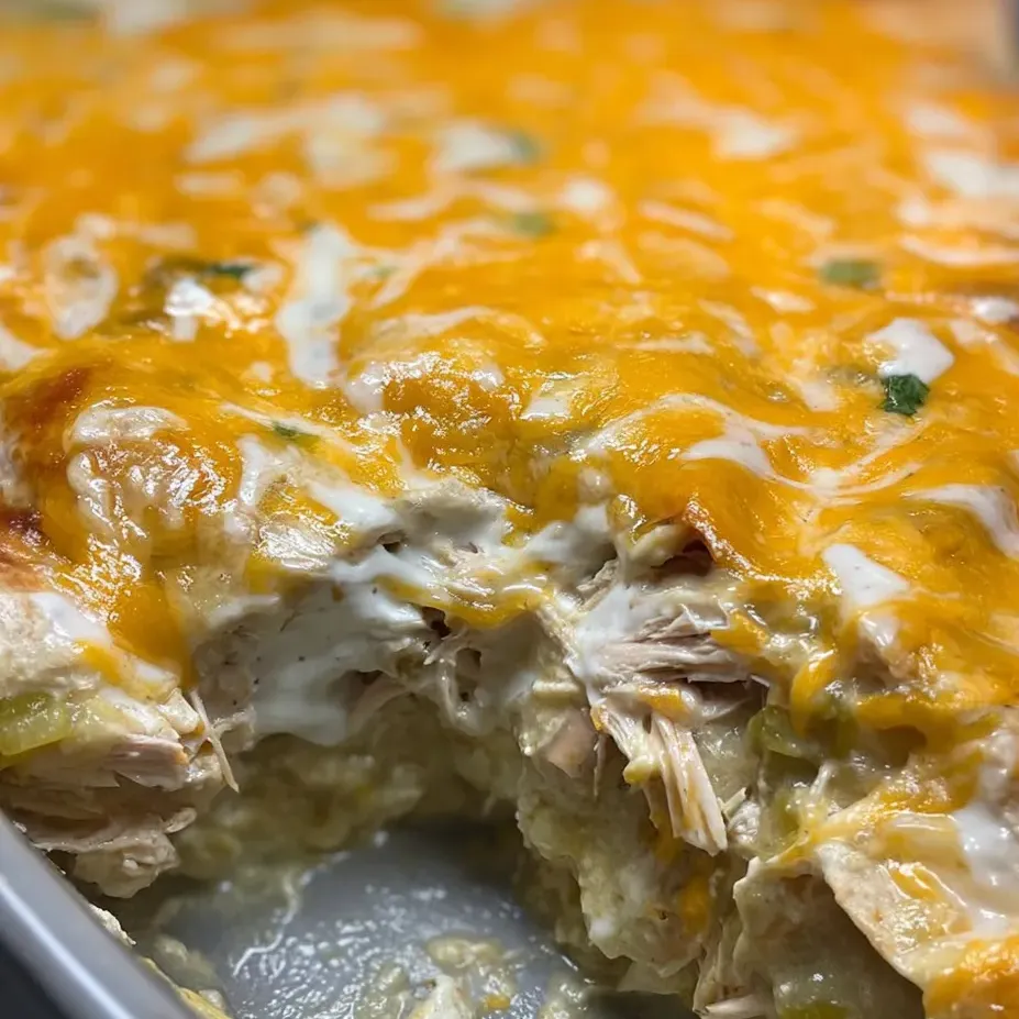 A cheesy chicken bake sliced for serving.
