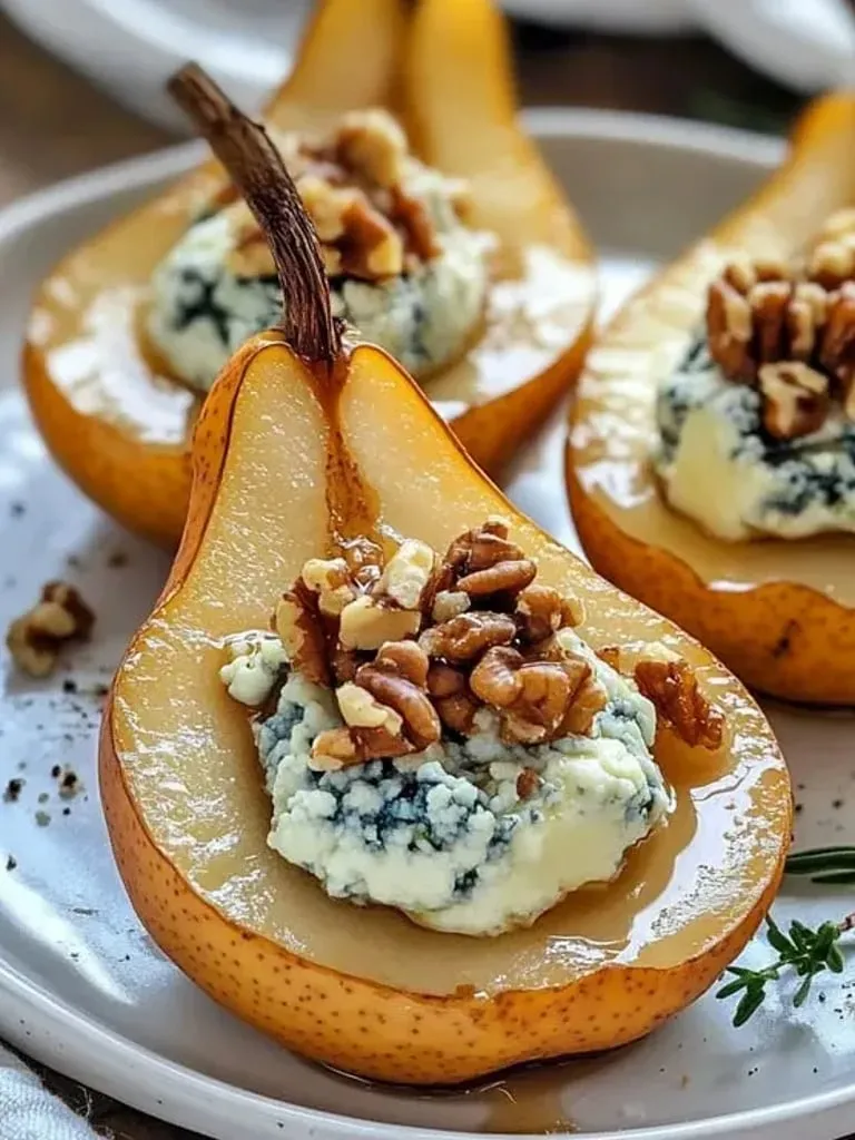 A dinner plate holding a pear half with walnuts.