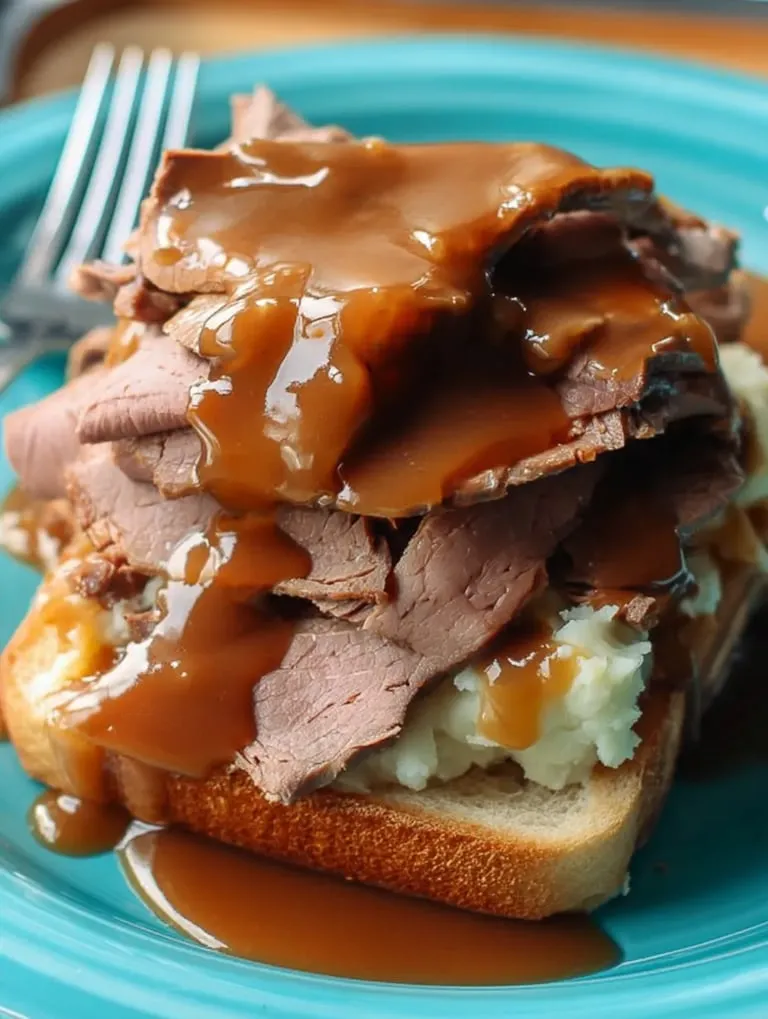 A plate of meat with gravy on top.