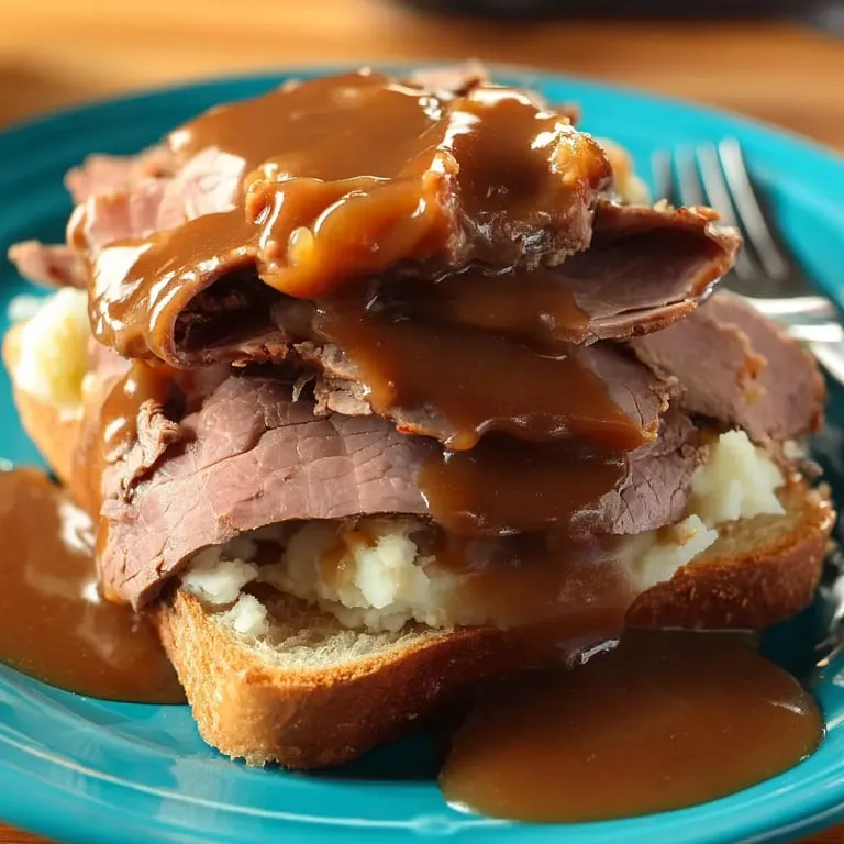 A plate piled with meat smothered in rich gravy.