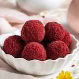 A bowl of red velvet cheesecake bites.