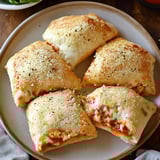 A plate of cheesy chicken pizza pockets.