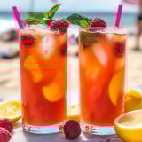 Two glasses of Raspberry Peach Lemonade on a table.