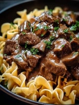 Beef tips served in a bowl with noodles.