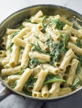 A tasty plate of pasta with spinach and cheese.