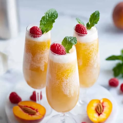 Three glasses of peach bellini mocktail.