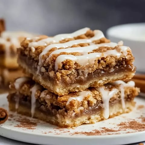 A stack of cinnamon roll blondies on a plate.