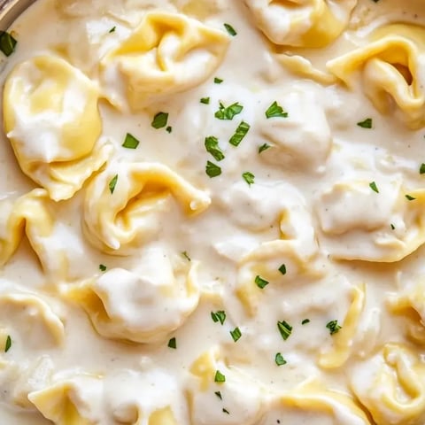 A bowl piled high with garlic Parmesan tortellini.