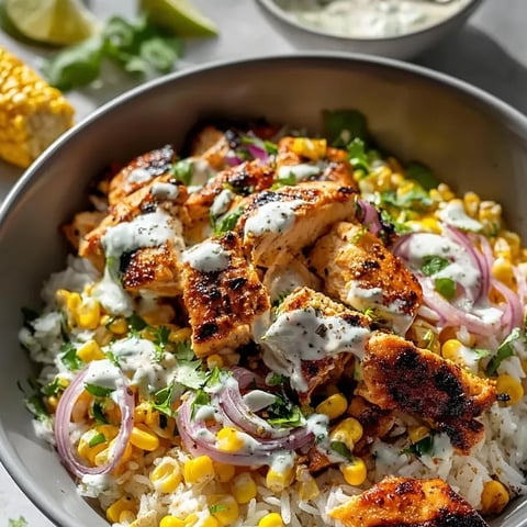 A bowl loaded with chicken, sweet corn, and onions.