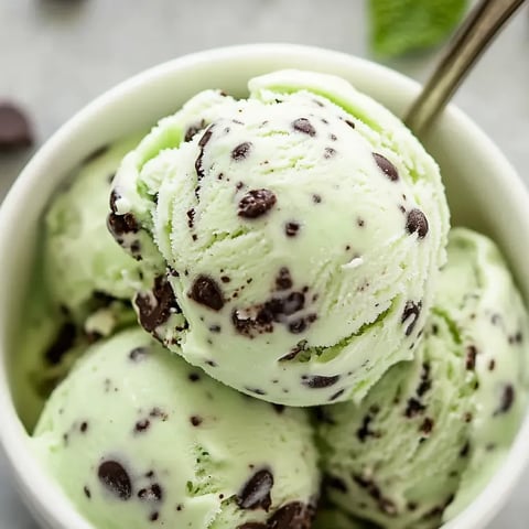 A bowl of ice cream with chocolate chips.
