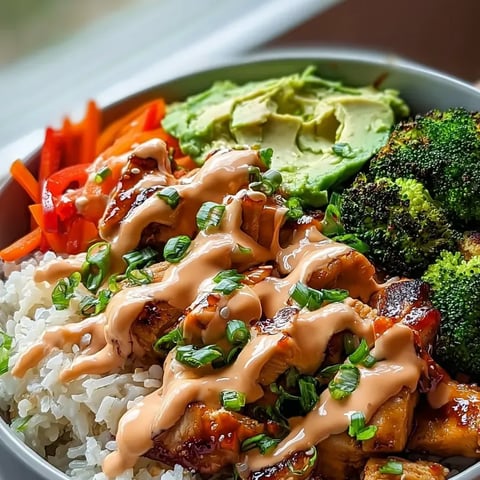 A bowl filled with rice, bright cooked broccoli, carrots, and more veggies.
