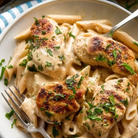 A plate of chicken and pasta.