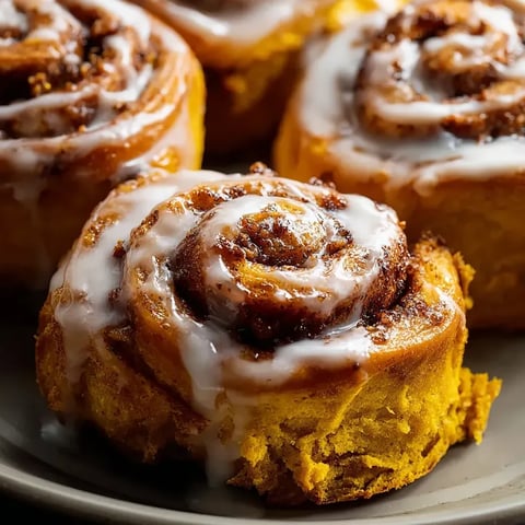 A plate holding two cinnamon rolls.